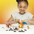 Child playing with toy figures on a table against a yellow background